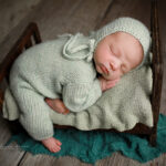 baby posed on bed