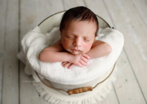 baby posed in bucket