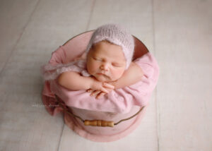 baby girl in pink bucket