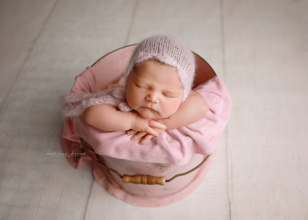 baby girl in pink bucket