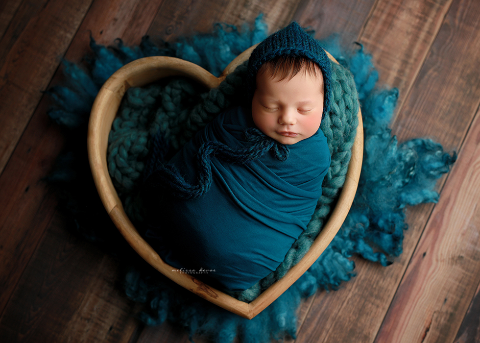 baby girl in heart bucket