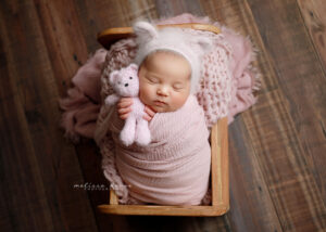 baby girl snuggling bear