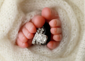 baby toes with wedding rings