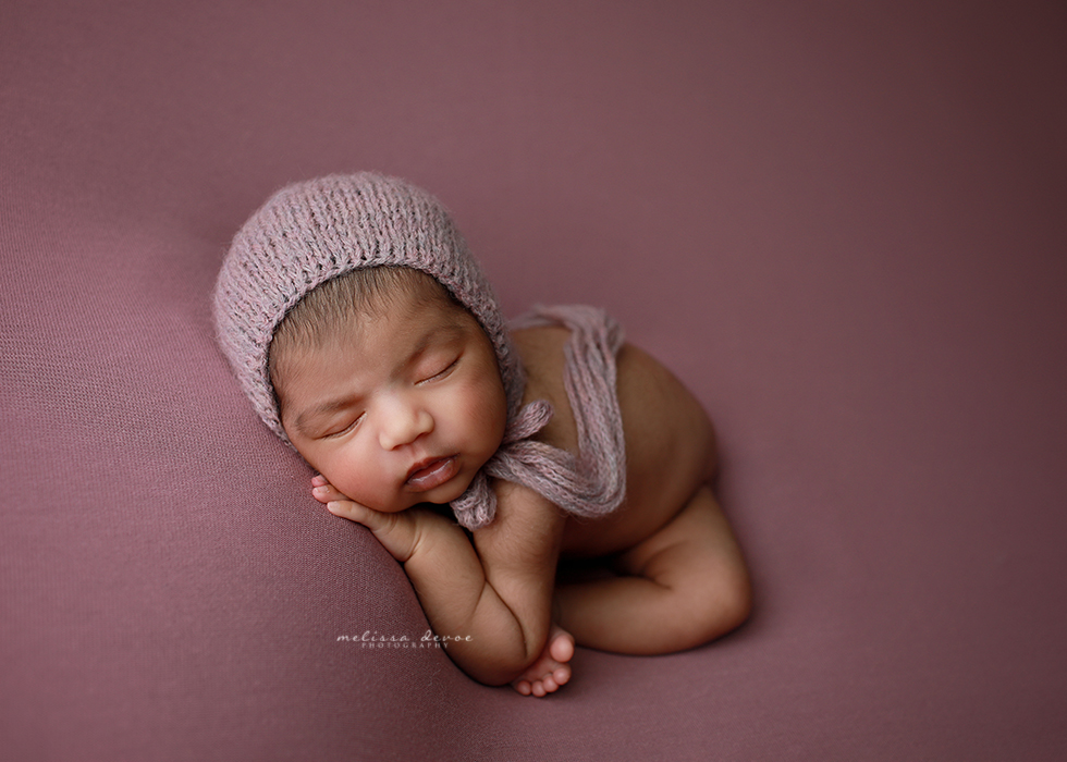 baby girl on purple blanket