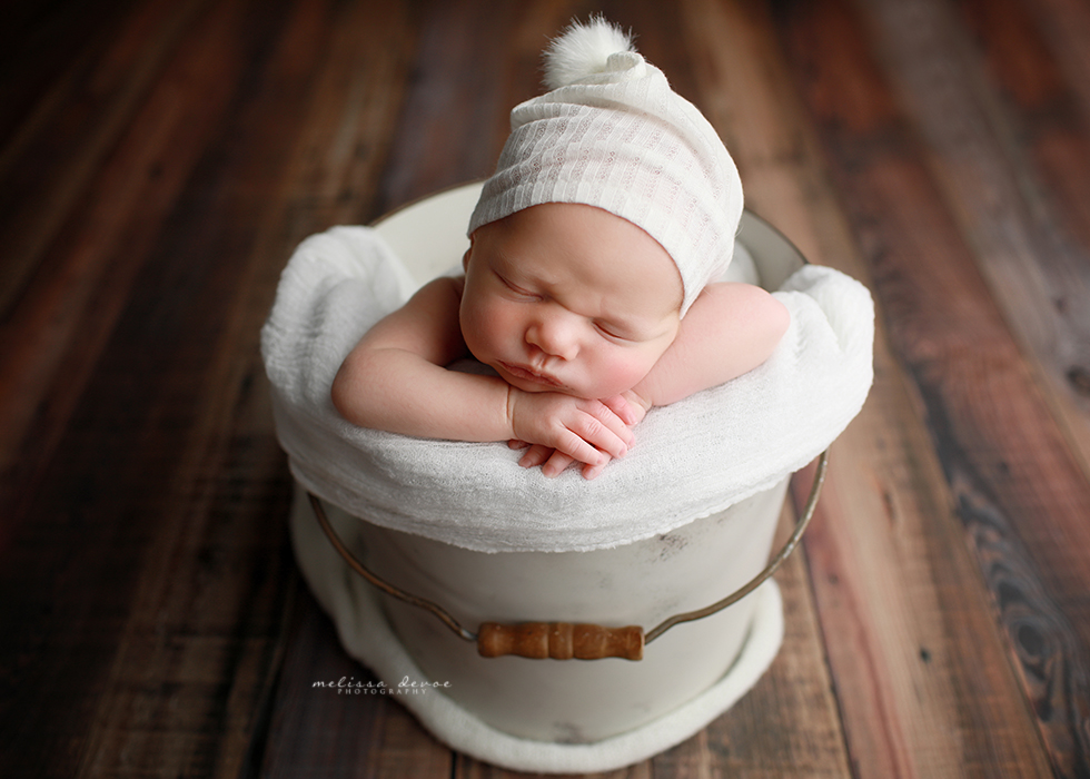 baby posed in bucket