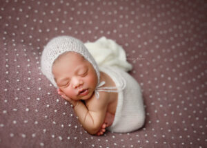 baby girl on purple blanket