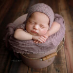 newborn posed in bucket