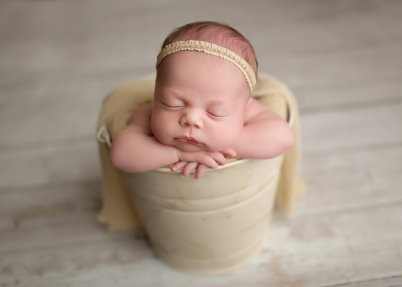 Raleigh Newborn Photography by Melissa Devoe baby girl sleeping in cream bucket with headband