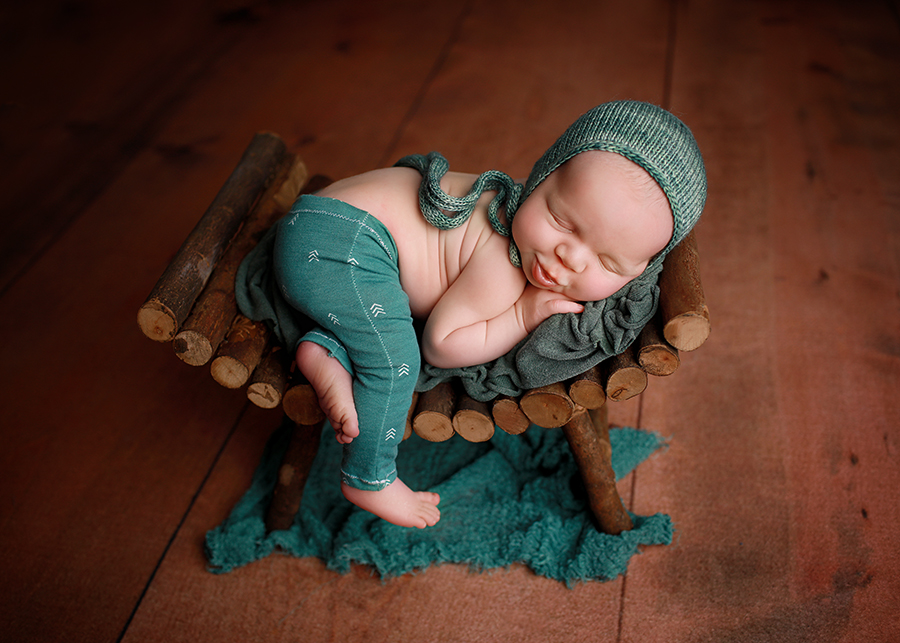 baby sleeping on bench