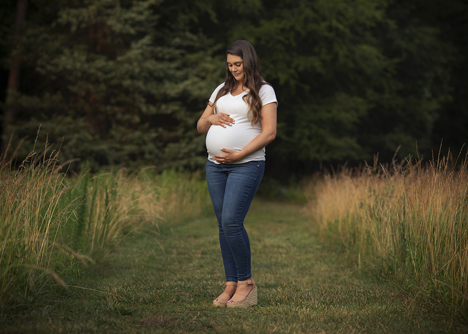 maternity photo in a field at sunset