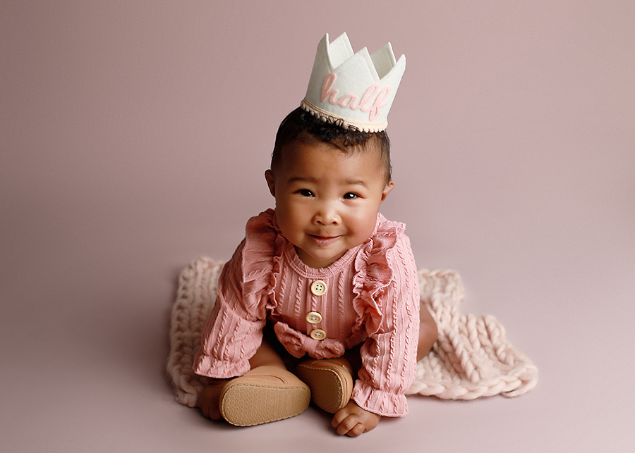 Baby girl on purple backdrop