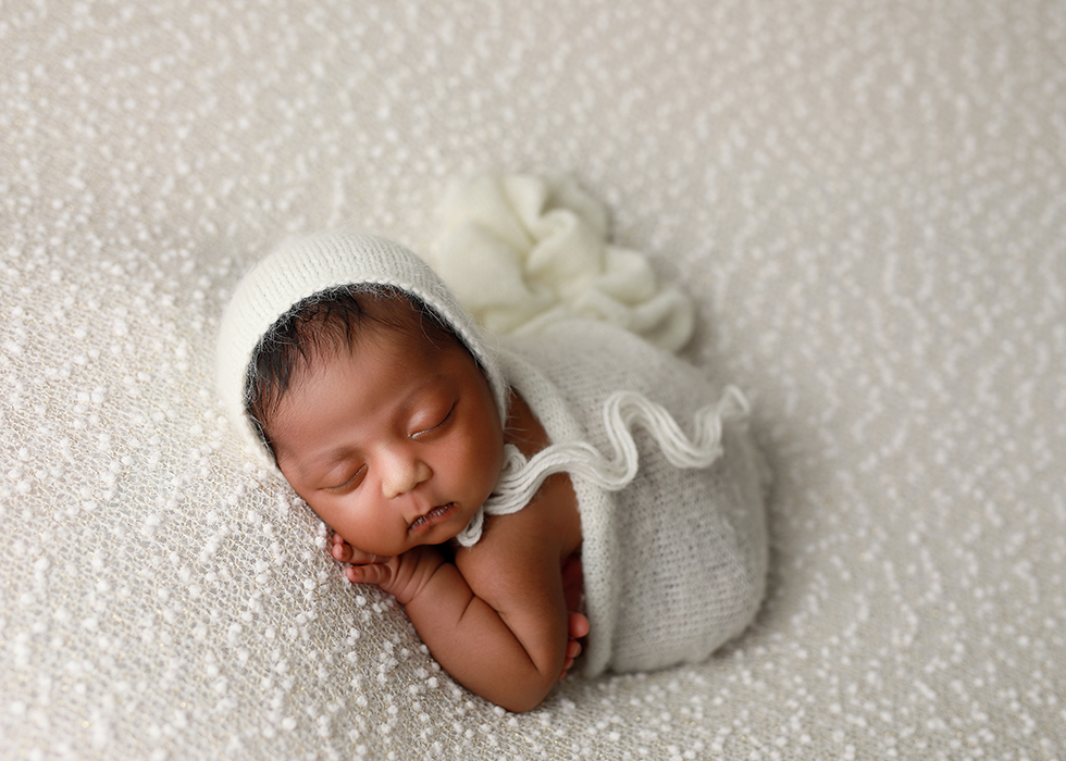 baby girl on white blanket