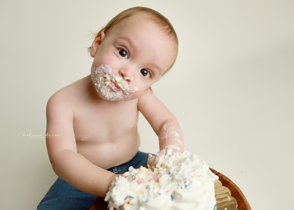 One Year old baby boy eating cake