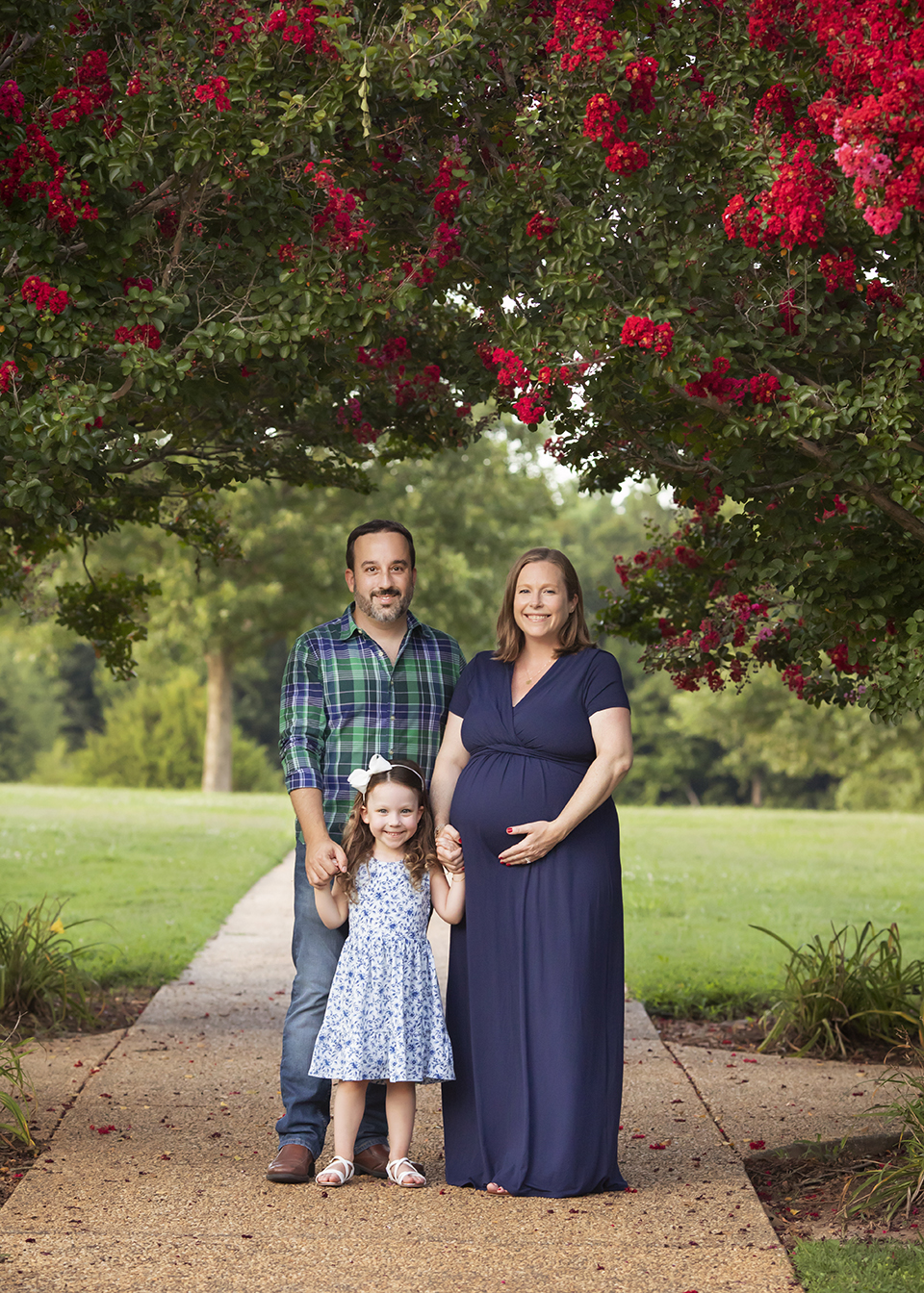 Family photoshoot at a park surrounded by flowers