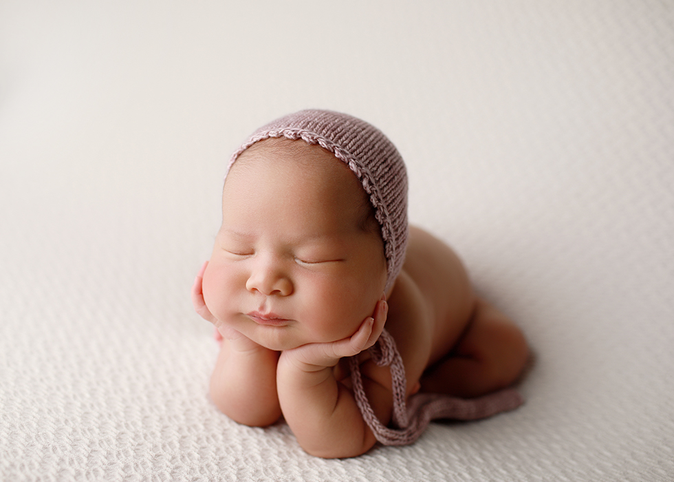 Raleigh Newborn Photography – Baby in Pink Bonnet Newborn baby posed in a pink bonnet by Raleigh newborn photographer Melissa Devoe Photography
