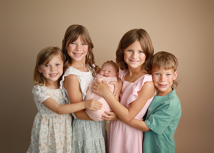 siblings with baby