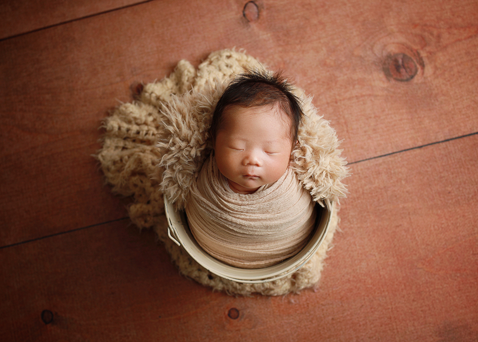 swaddled newborn boy