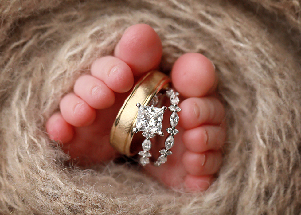 baby toes with Mom and Dad's wedding rings. Newborn photography